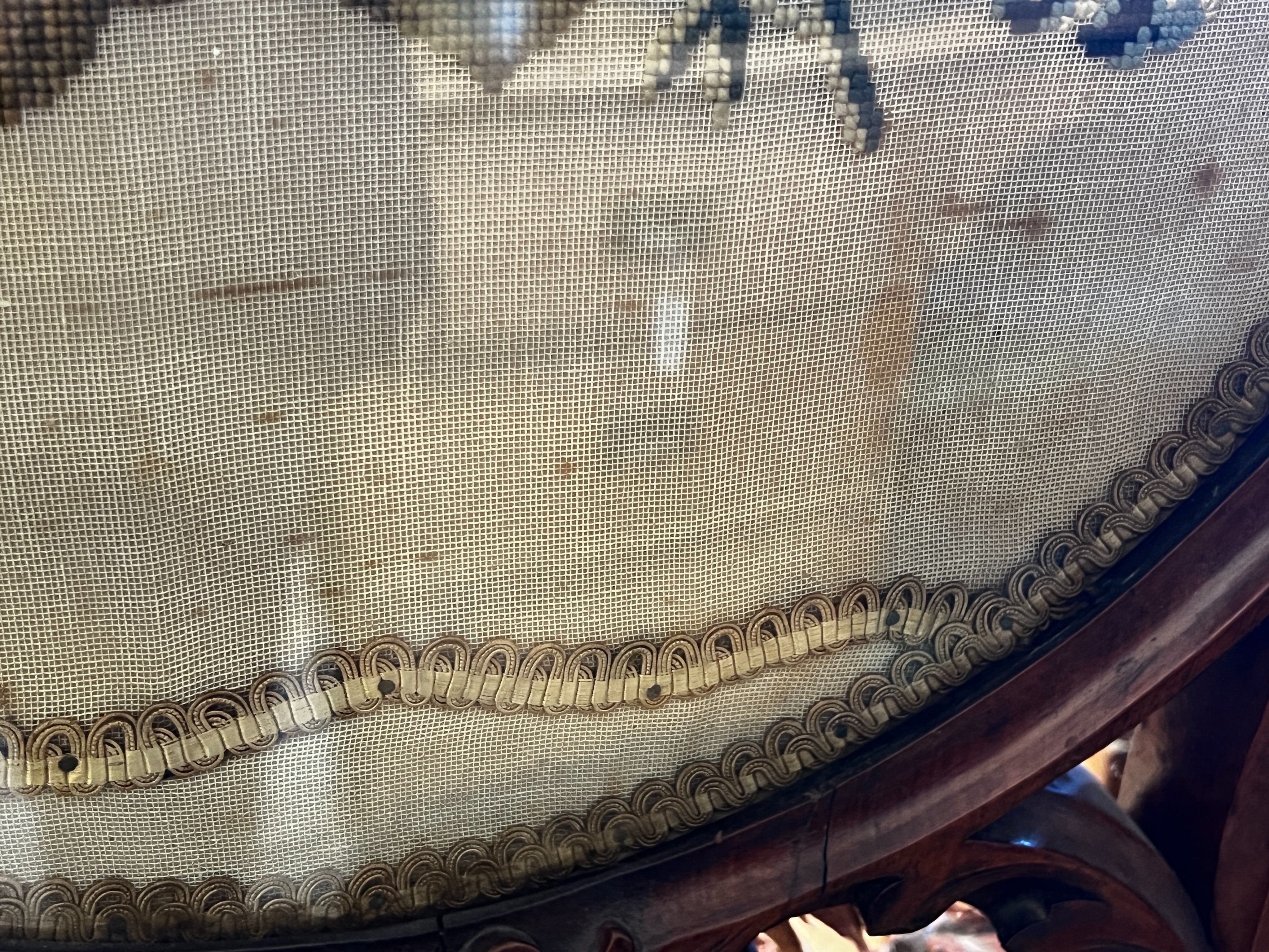 A Victorian carved walnut fire screen with needlework parrot banner, width 56cm, height 99cm